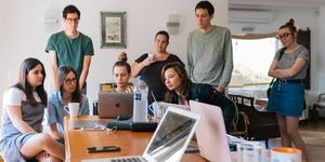 Youth gathered around a laptop.