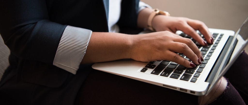 Woman typing on keyboard.