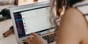 Woman typing on laptop.